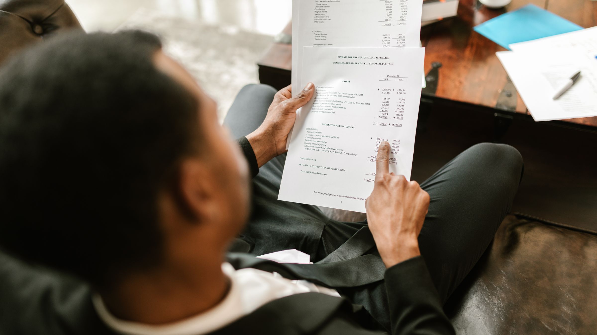 A tax professional reviewing financial documents with a client